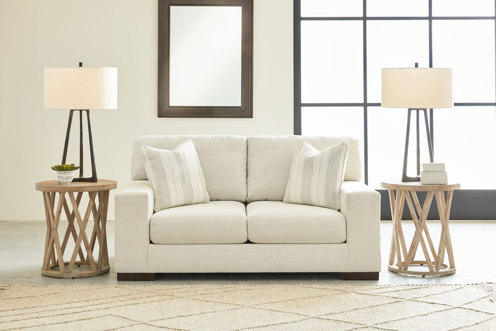 Light beige living room sofa with three throw pillows