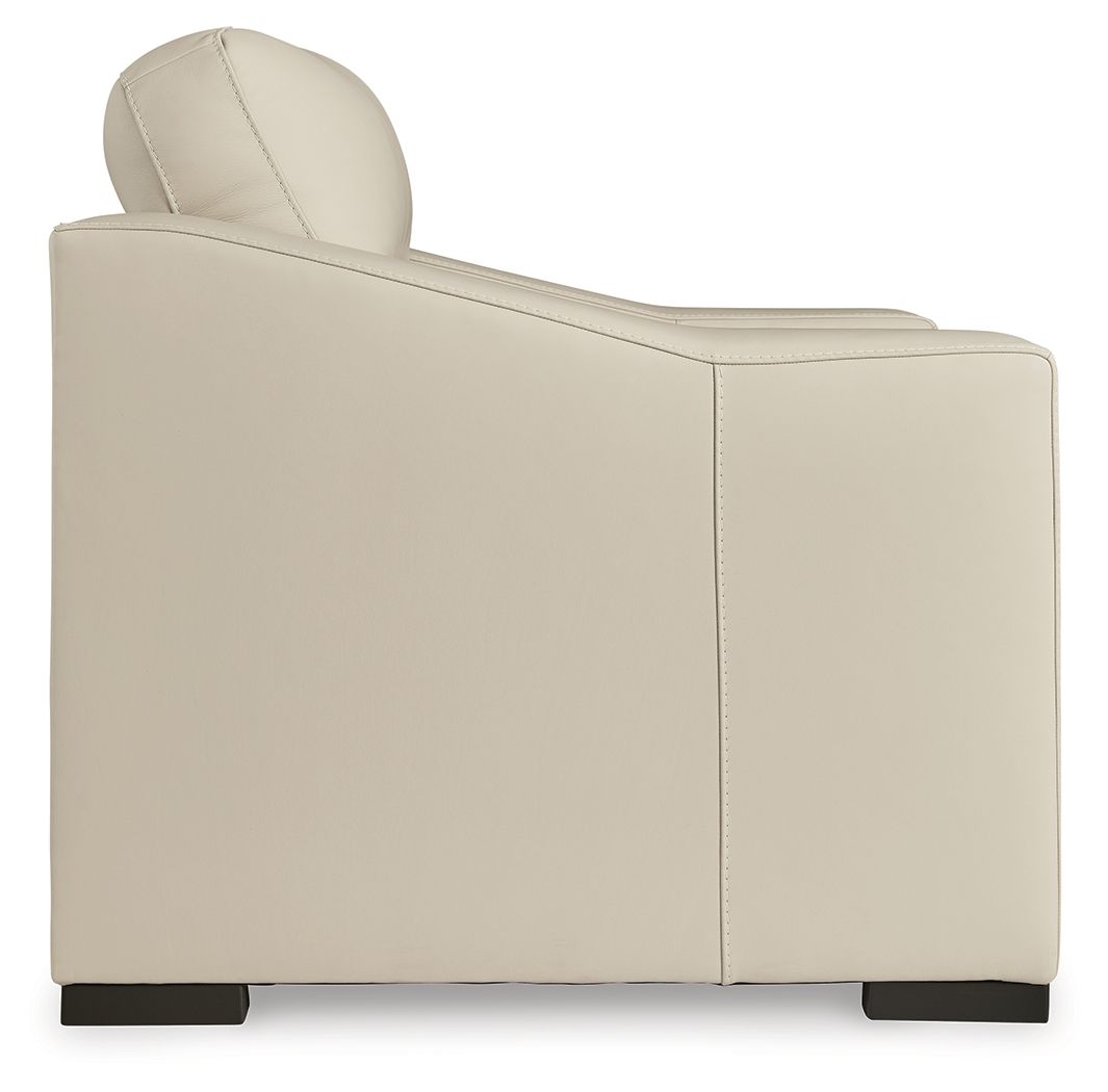 Almond upholstered armchair with rounded back, padded arms, and dark legs