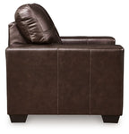 Dark brown leather accent chair side view with curved back cushion