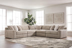 Burlap-upholstered sectional sofa corner with chaise seats and stacked throw pillows