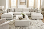 Beige sectional sofa with corner chaise section, throw pillows, and tufted seat cushions