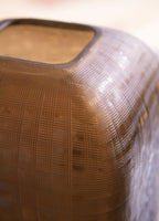 Dark brown vase close-up with basket-weave texture and open rim edge