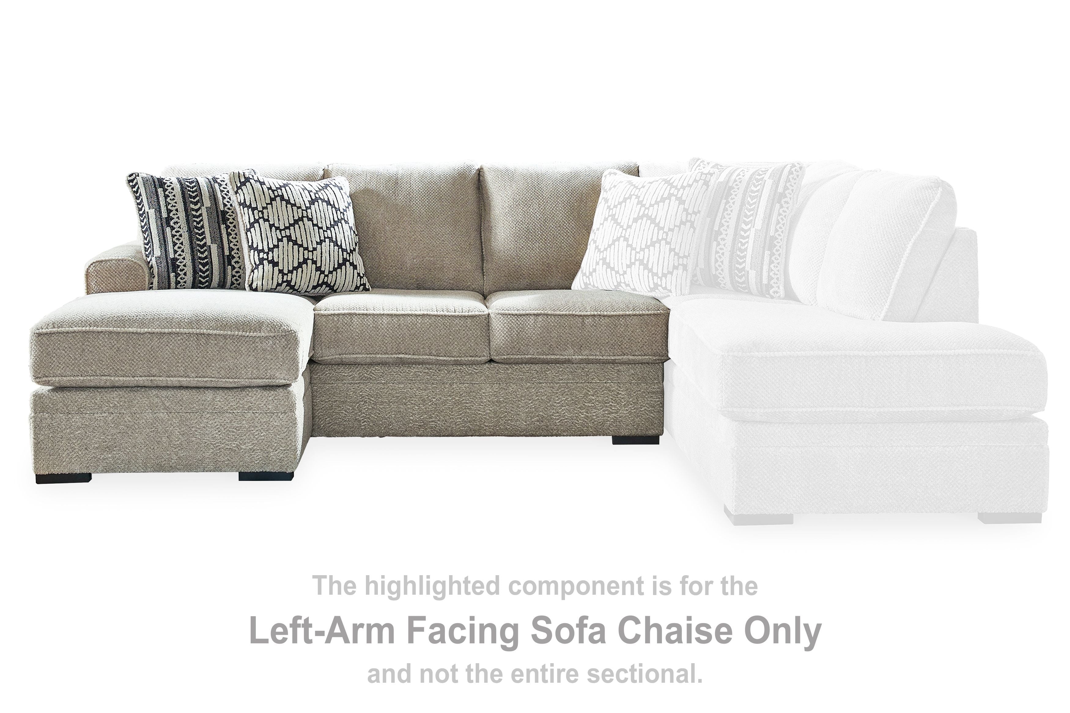 Gray and white sectional sofa chaise with tufted cushions and patterned accent pillows