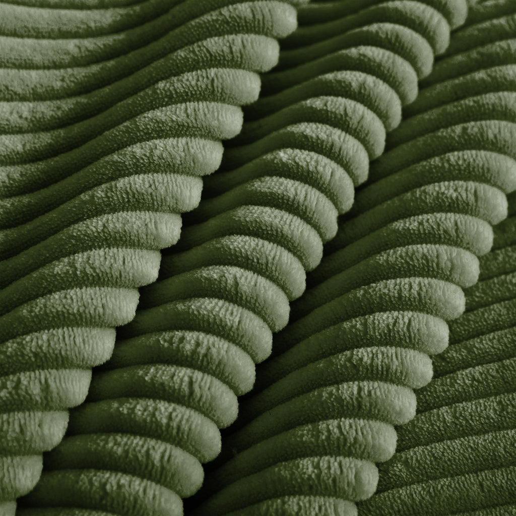 Green corduroy upholstery fabric close-up with dense ribbed texture