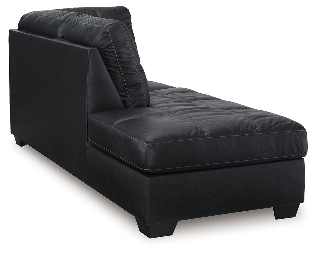 Dark upholstered chaise lounge with curved backrest and tufted seat