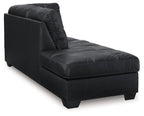 Dark upholstered chaise lounge with curved backrest and tufted seat