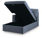 Ink blue corner chaise with storage, open lid showing inner compartment