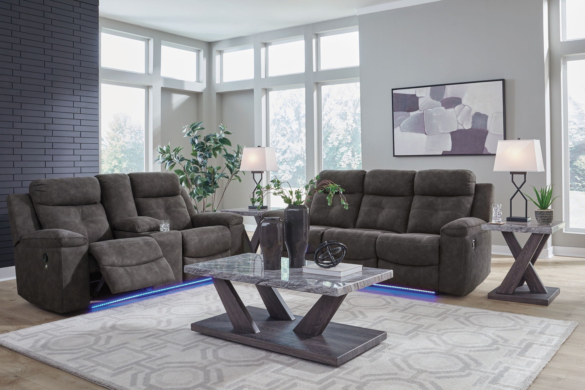 Dark gray reclining sofa and loveseat set with padded armrests