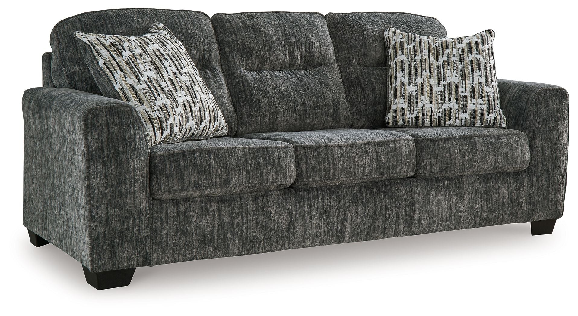 Dark gray fabric sofa with two patterned accent pillows and wide arms
