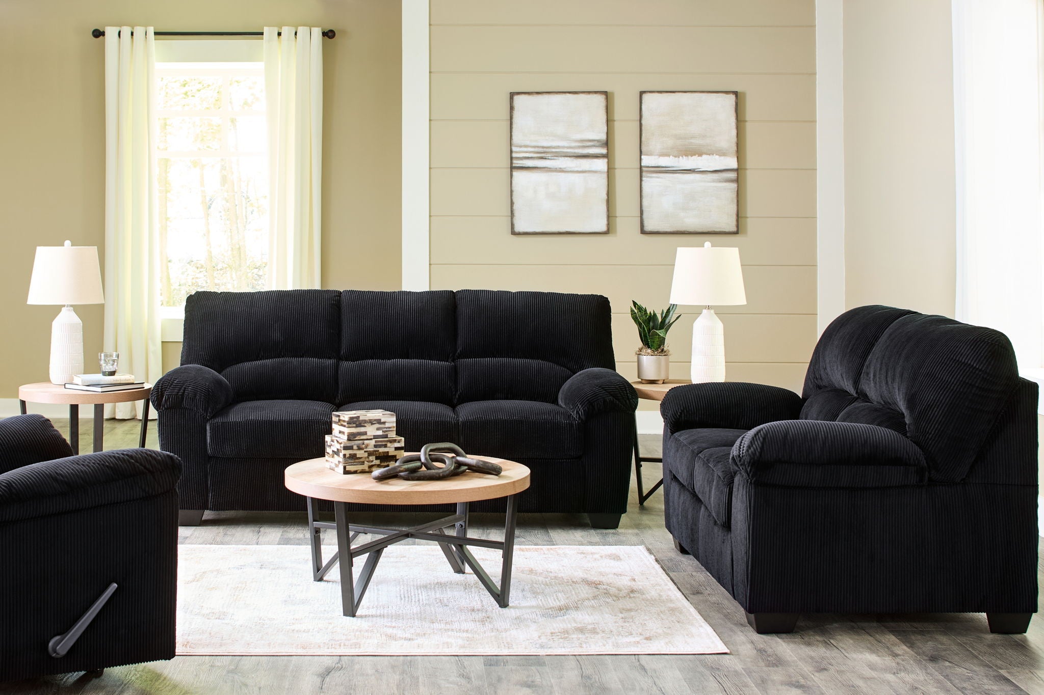 Black sofa and recliner with deep seats and padded arms