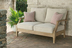 Beige lounge sofa with two back pillows and solid seat cushions on wood frame