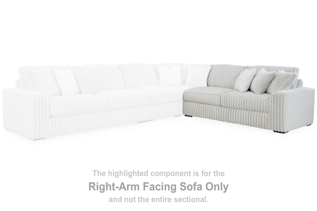 Light gray sectional sofa corner with ribbed upholstery and cushioned seat