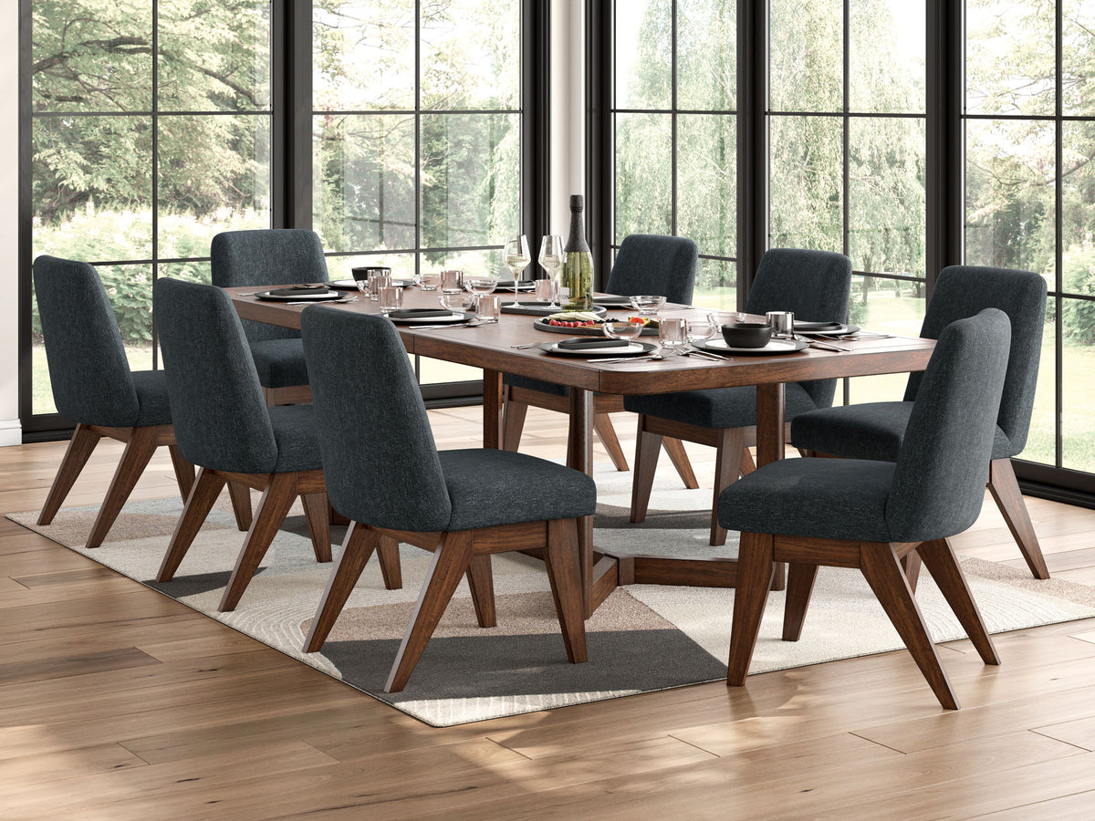 Dining table set in dark brown with six dark gray upholstered chairs by window