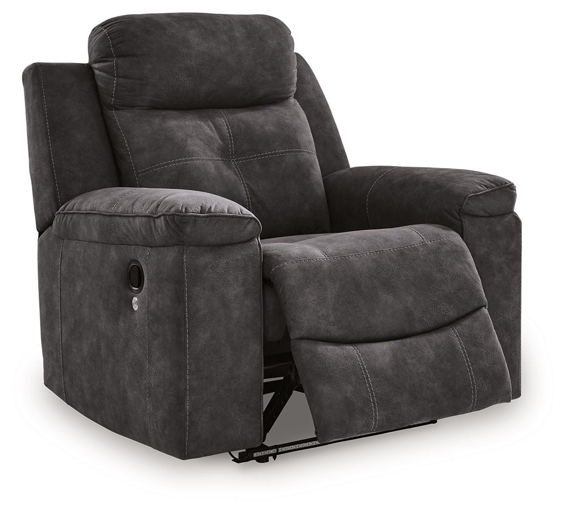 Charcoal zero-wall recliner with fold-down footrest, padded headrest, and cushioned arms