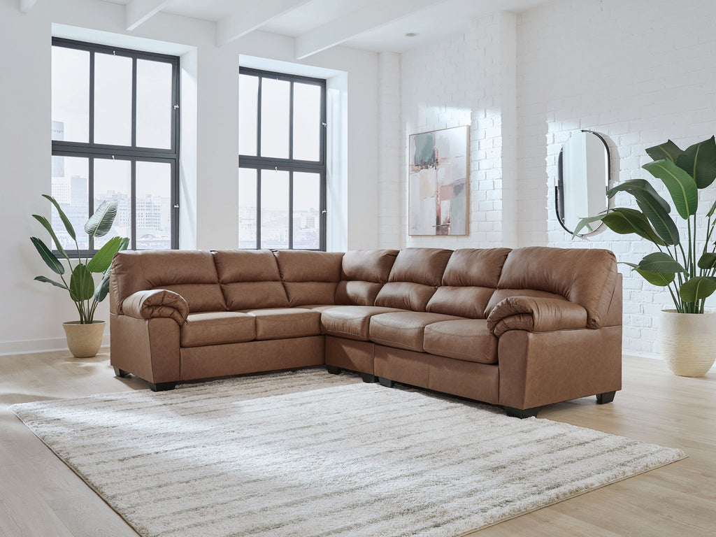 Sectional sofa with tufted cushions and rolled arms, warm brown upholstered fabric