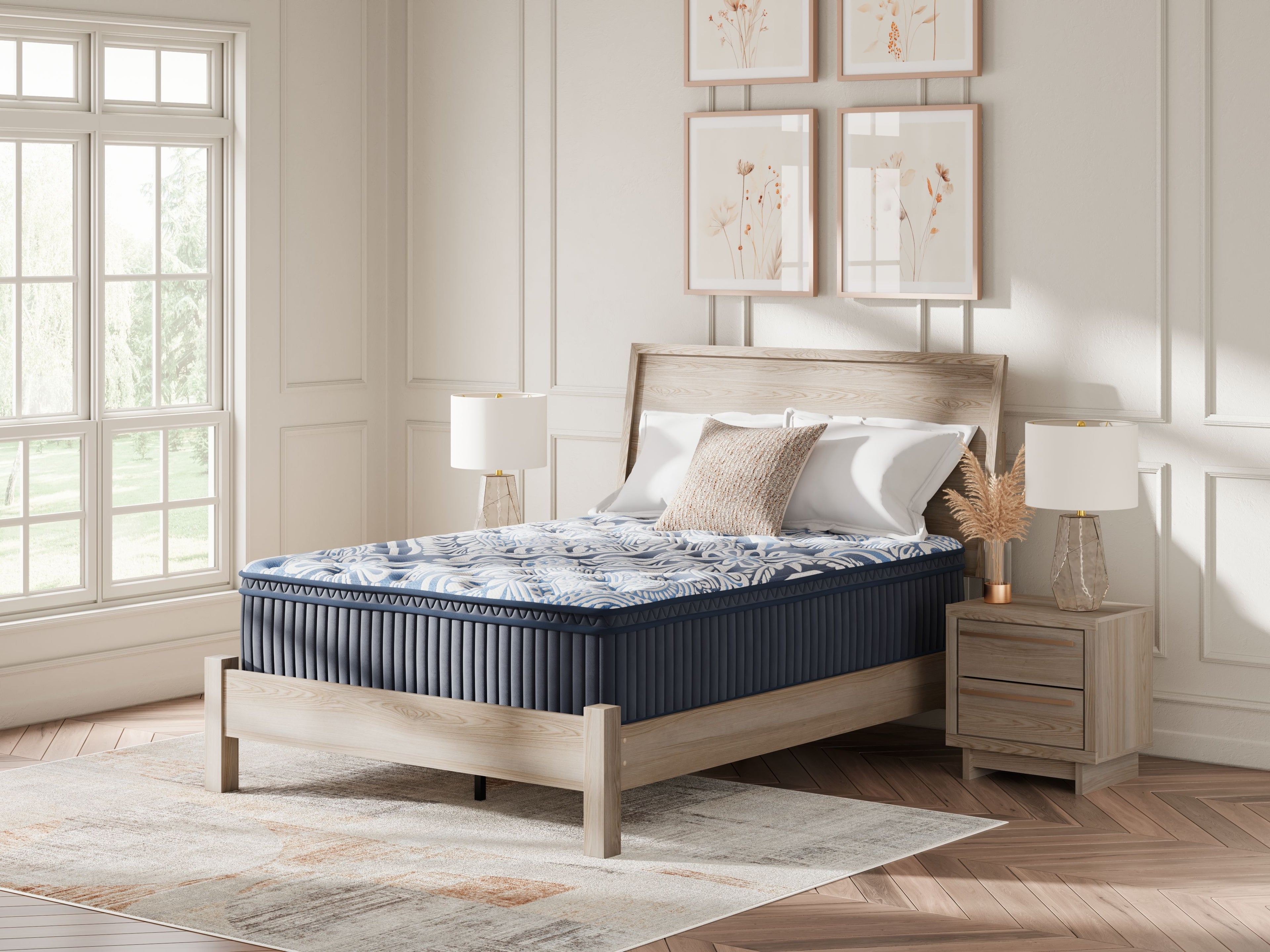 Blue mattress on bed with patterned quilted surface and white pillows