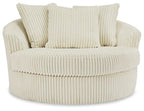 Beige oversized swivel accent chair with ribbed fabric and three seat-back pillows