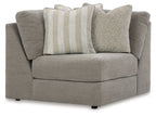 Gray upholstered wedge sectional sofa with rolled arms and two throw pillows