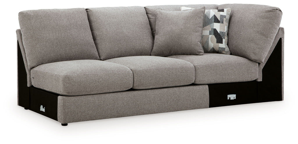 Smoke armless loveseat with wedge, gray fabric upholstery and tufted seat cushions, black base