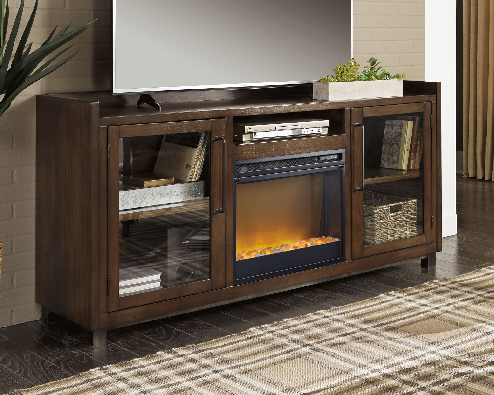 Brown TV stand with built-in fireplace insert, glass doors, and open side shelves