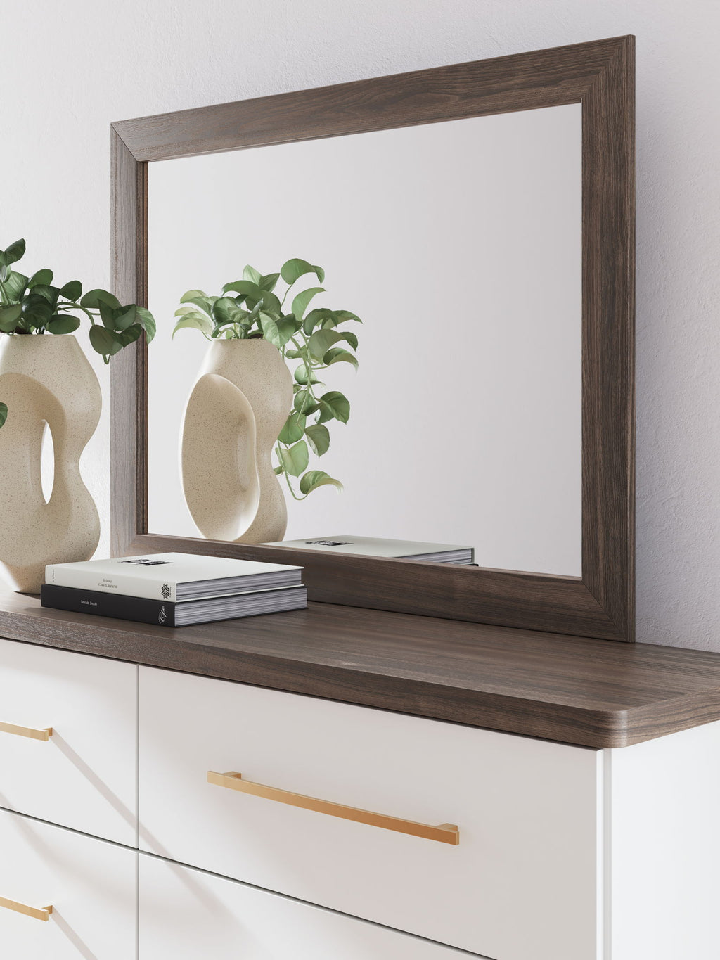 Rectangular bedroom mirror with dark brown wood frame and ledge on dresser top