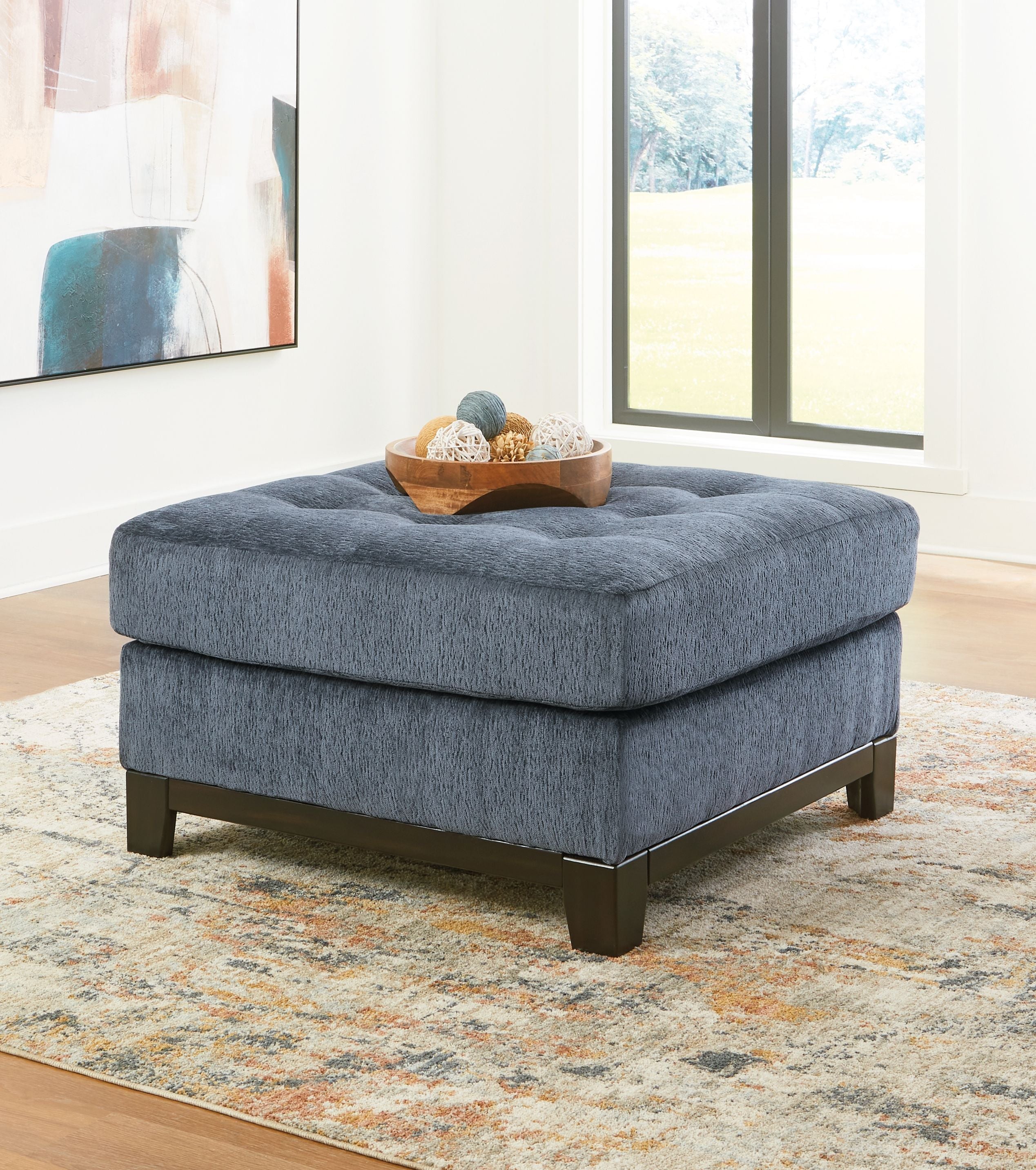 Blue oversized accent ottoman with tufted top and dark block feet