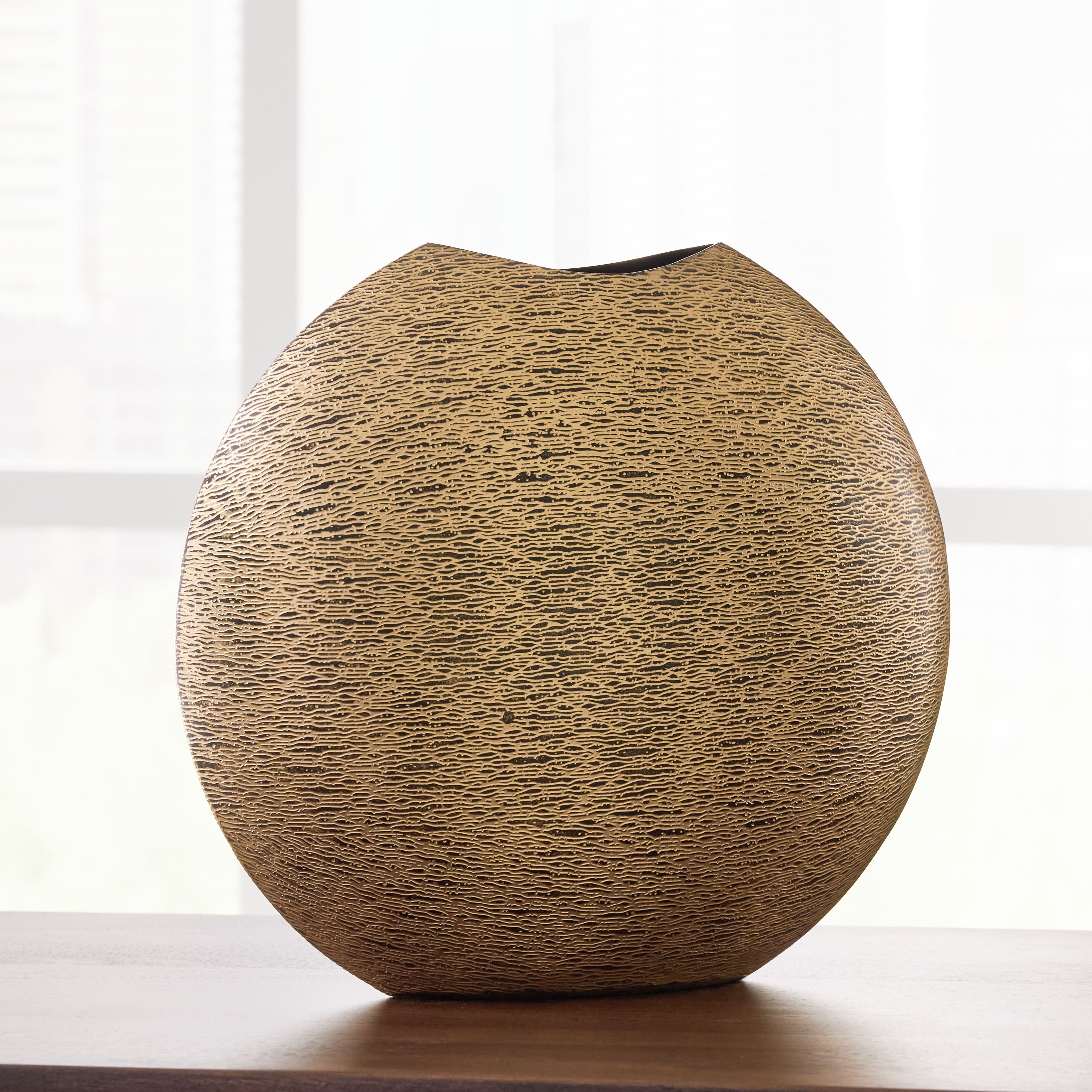 Gold textured vase with rounded teardrop body and dark top opening