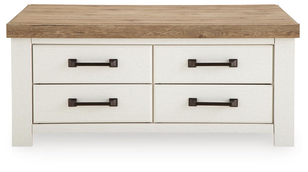Rectangular table with wood top, four drawer fronts, and dark bronze bar handles.