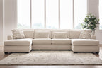 Beige sectional sofa with chaise lounges, tufted back cushions, and patterned accent pillows.