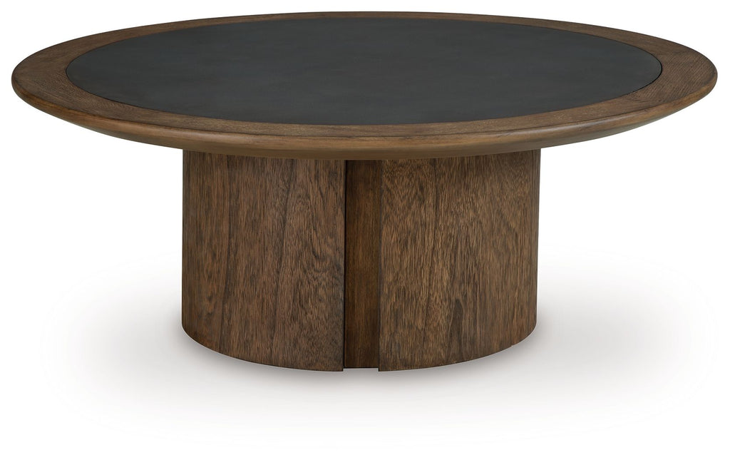 Dontayne round table with dark top and dark brown cylindrical pedestal base.