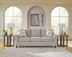 Taupe upholstered sofa with loveseat set, square arms, patterned throw pillows
