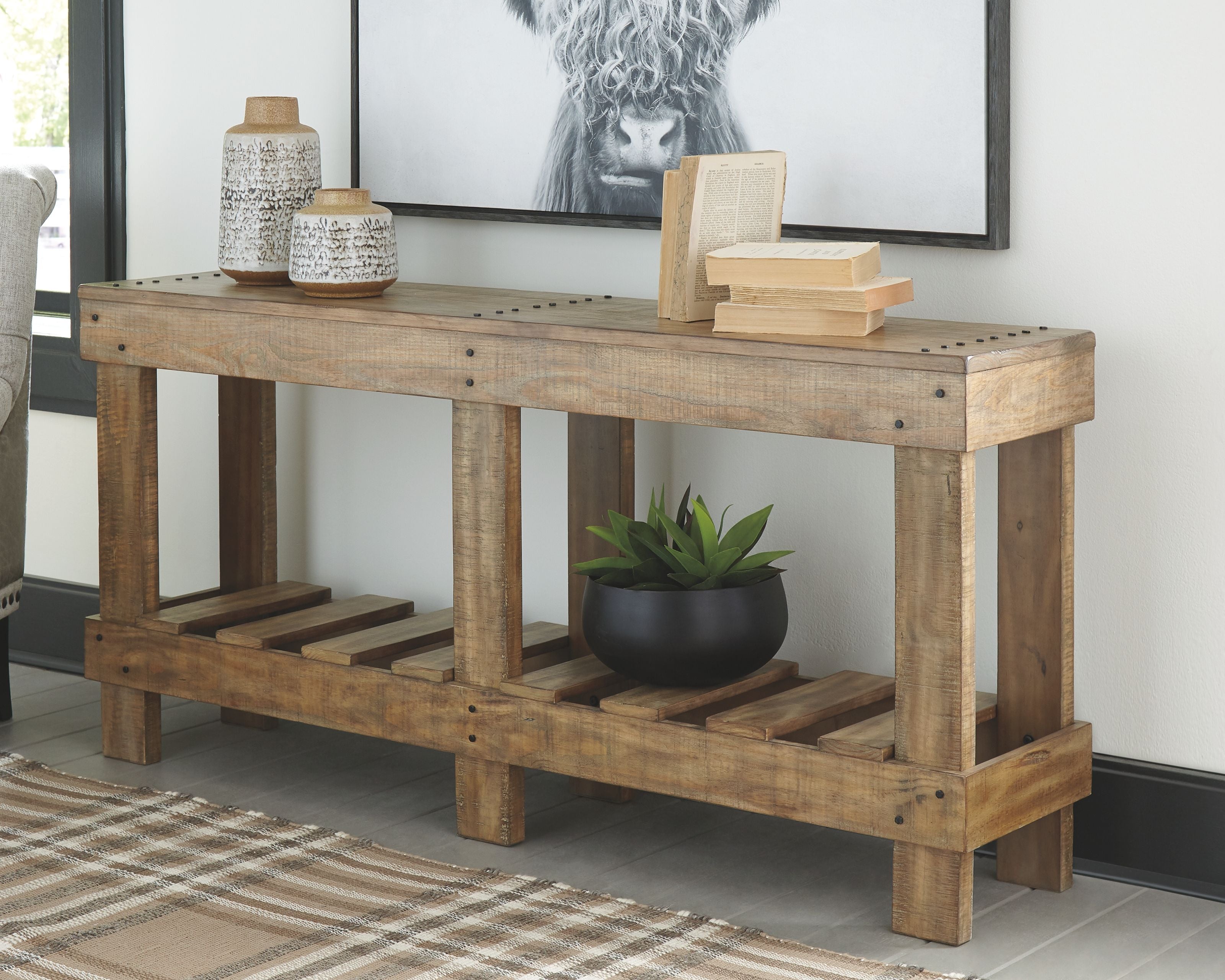 Console sofa table in distressed light brown wood with open slat lower shelf.