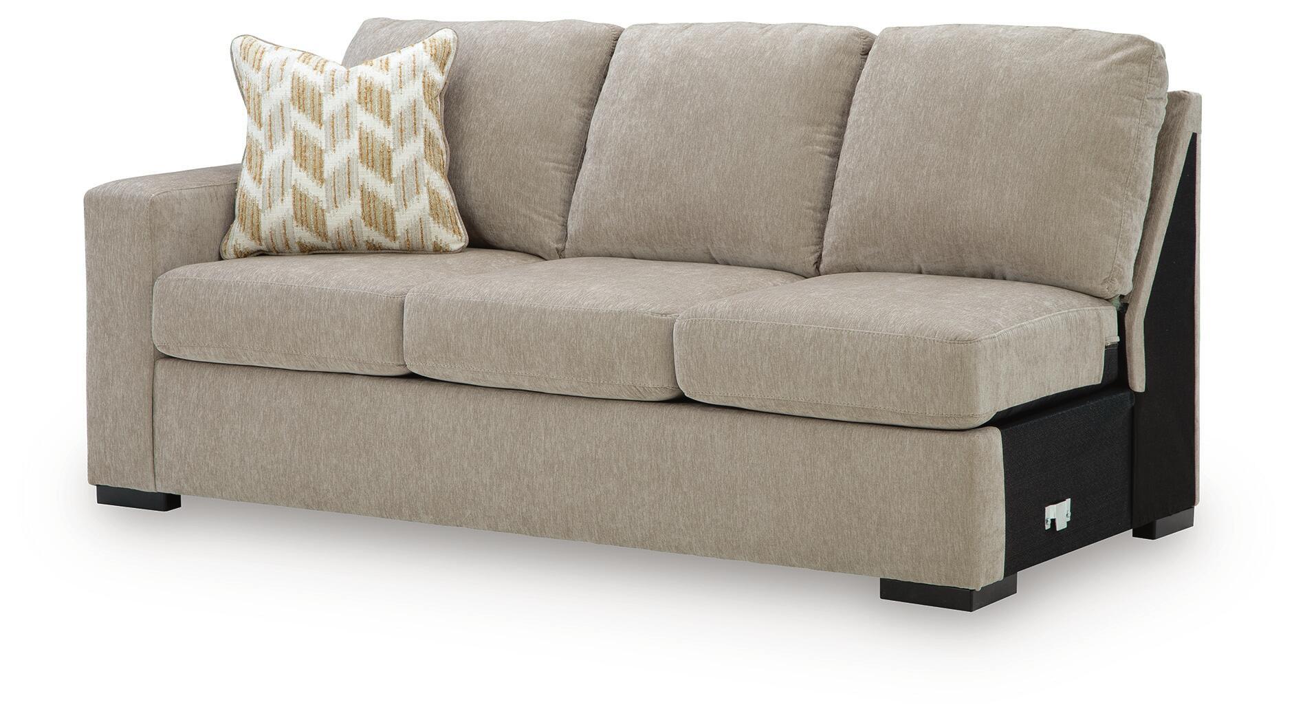 Stone-beige fabric sofa with patterned throw pillow, upholstered seat cushions, black legs