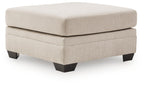 Beige upholstered ottoman with square cushioned top and dark wood legs