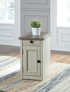Chair side end table in light white finish with door, drawer, and top shelf