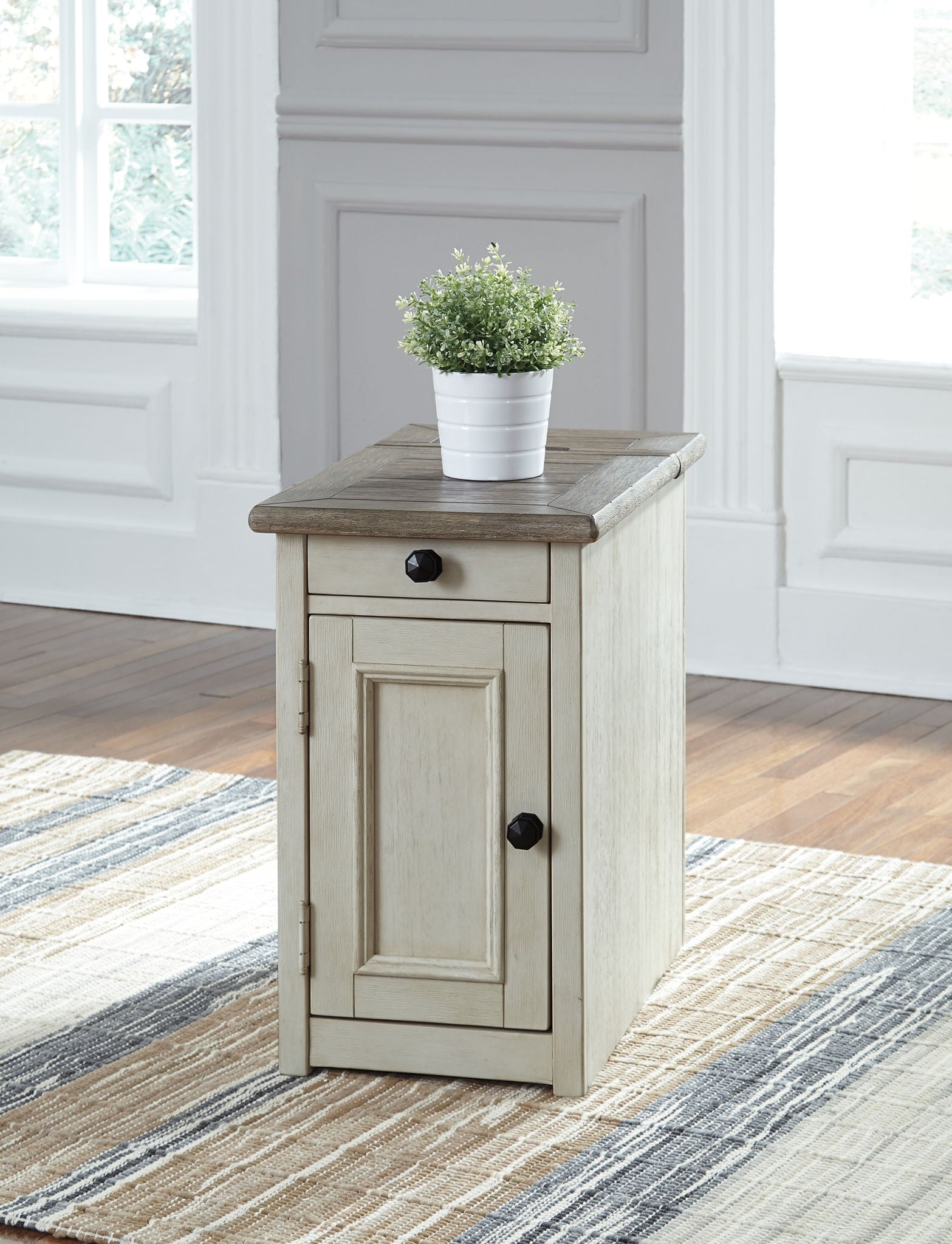 Chair side end table in light white finish with door, drawer, and top shelf