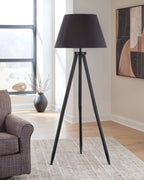 Black floor lamp with dark conical shade and three-legged tripod base