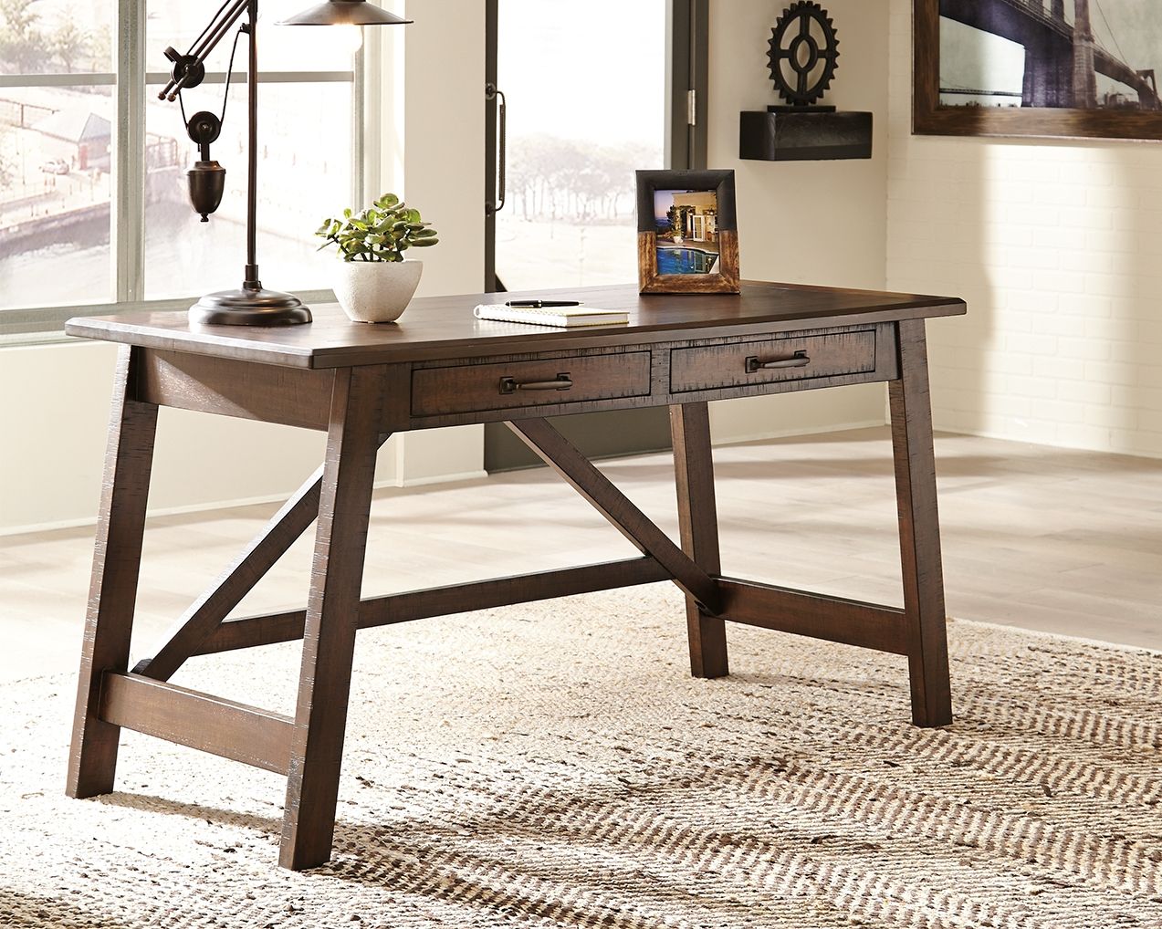 Rustic brown office desk with three drawers and angled cross braces