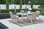 Outdoor dining set with light gray arm chairs and table with glass top