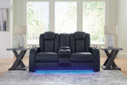 Dark blue power reclining loveseat with center console and tall padded headrests
