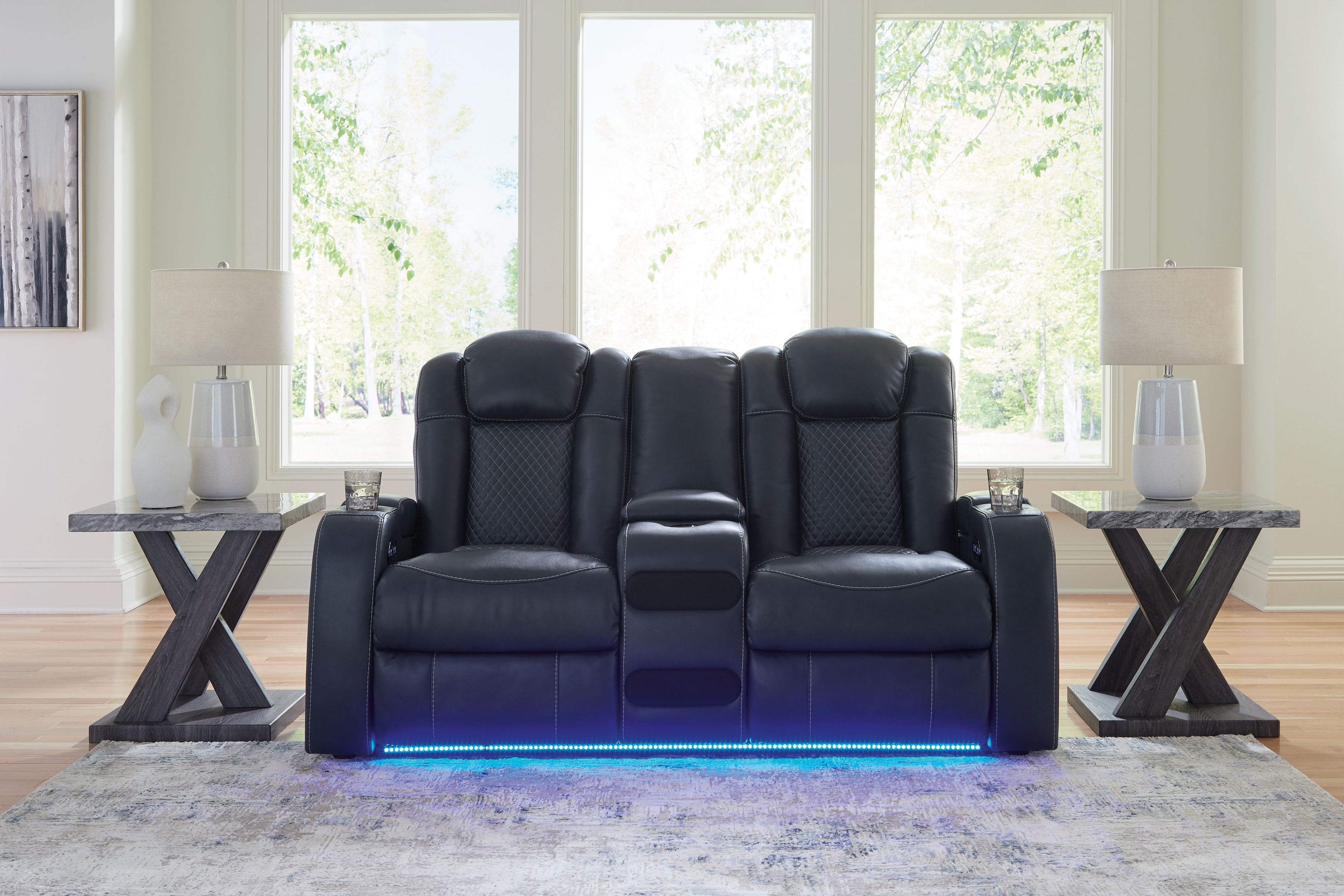 Dark blue power reclining loveseat with center console and tall padded headrests