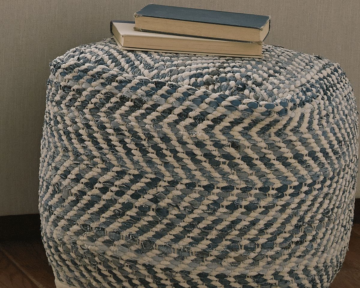 Blue-and-cream chevron fabric pouf with plush rounded sides and square top