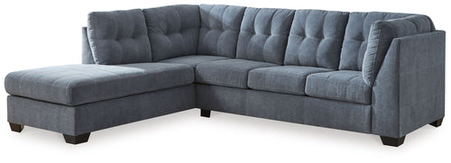 Dark gray sectional sleeper sofa with tufted back and chaise corner, square arms