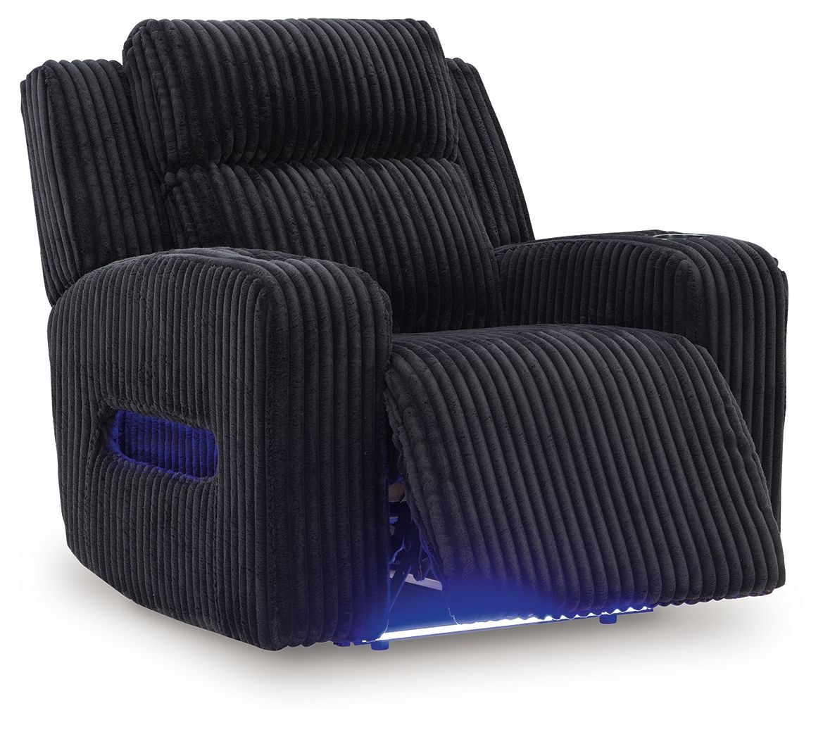 Black corduroy recliner with adjustable headrest in reclined position