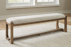 Upholstered dining bench, oatmeal seat with light brown frame and low shelf, angled view
