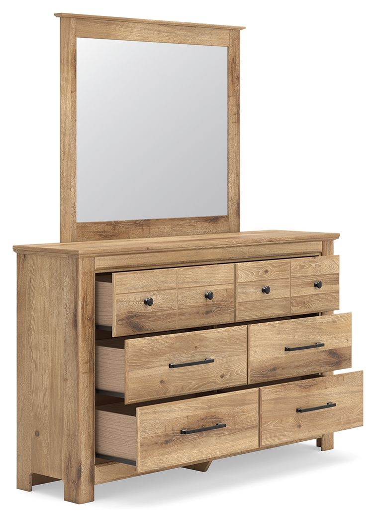 Light brown dresser with six drawers and bar pulls, mirror leaning on top