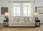 Light gray fabric loveseat sofa with patterned pillows and matching side table lamps