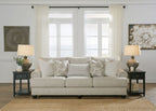 Fog light-gray sofa with tufted cushions and multiple patterned pillows, dark legs