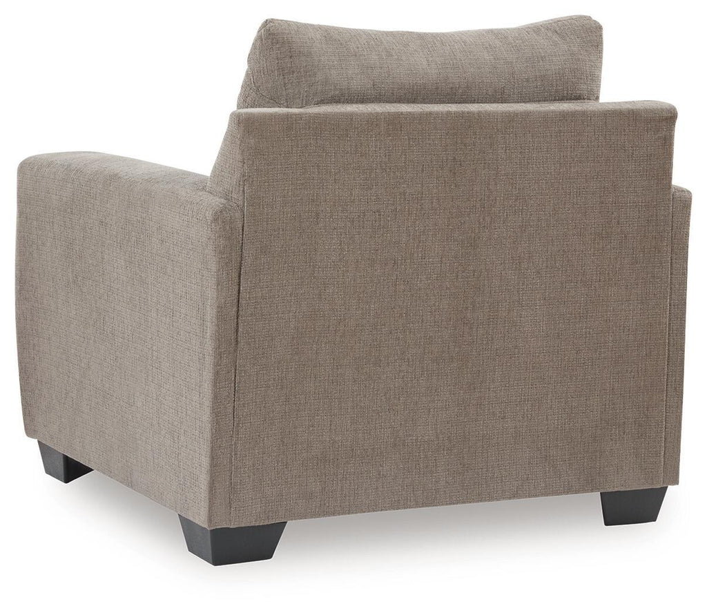 Loreo chair in light brown beige fabric with side profile, boxy arms, and dark feet