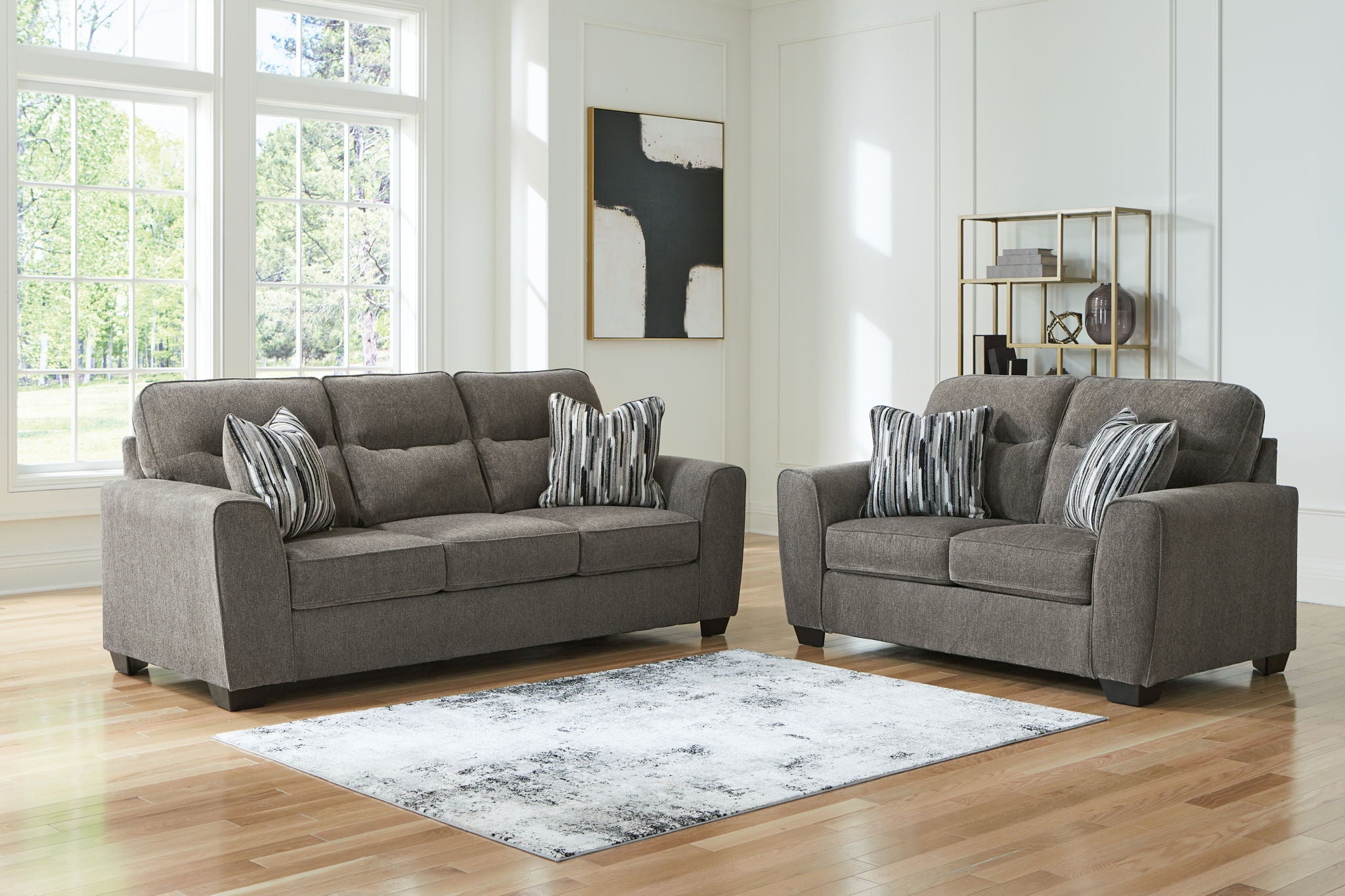 Dark gray fabric sofa and chair set with striped throw pillows